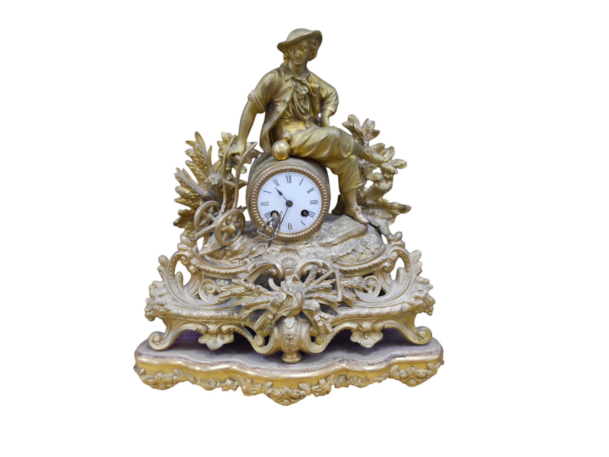 A 19th century French gilt spelter with seated youth mantel clock, with key and pendulum, 43cm. Condition - fair to good, not tested